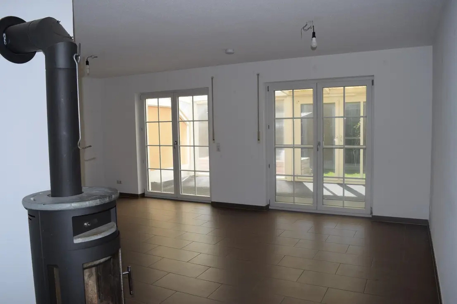 Michaela Hain Immobilien - Wohnung Wohnzimmer mit großer LED, Balkonblick